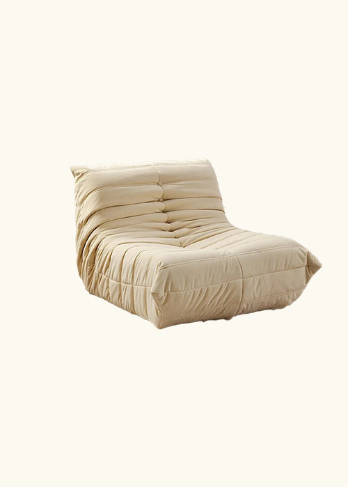 A trendy and comfy Caterpillar/Togo Chair in pale wheat color with solid wood infrastructure, plush faux suede cover, and sponge filling. Featuring a special concave ergonomic design for support and good posture. Removable and washable cover. Dimensions: W76cm x H70cm x D100cm.