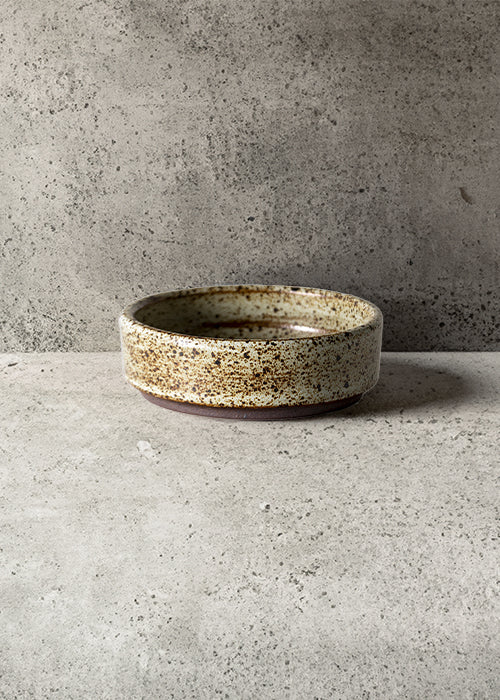 Handmade stone flat dish, measuring W9.2cm x H3cm. Featuring a rugged yet sleek style, this dish is part of a comprehensive set of raw pottery dishes and mugs designed for versatile dining needs.