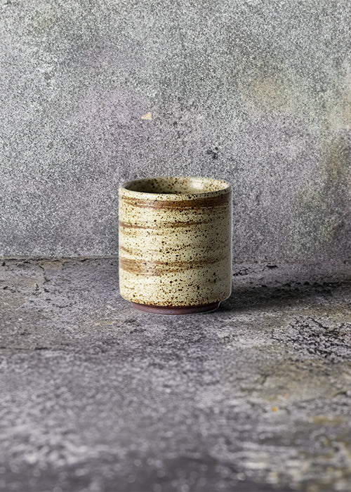 Handmade stone straight mug, measuring W6.3cm x H7cm. Exhibiting a rugged yet sleek style, this mug is part of a comprehensive set of raw pottery dishes and mugs designed for versatile dining needs