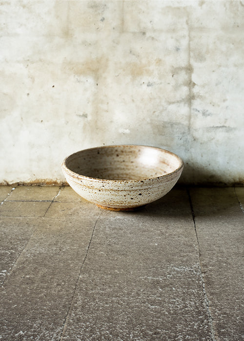 Handmade stone round bowl, measuring W12.5cm x H4.5cm. Featuring a rugged yet sleek style, this bowl is part of a comprehensive set of raw pottery dishes and mugs designed for versatile dining needs