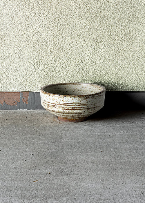 Handmade stone tapered dish, measuring W11.7cm x H5.5cm. Featuring a rugged yet sleek style, this dish is part of a comprehensive set of raw pottery dishes and mugs designed for versatile dining needs.