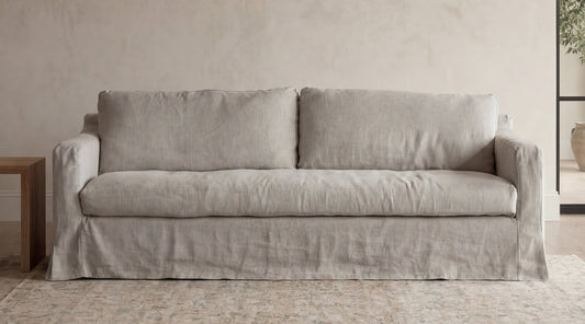 Wabi Linen Sofa in natural linen, two-seater, skirted base, japandi living room setting
