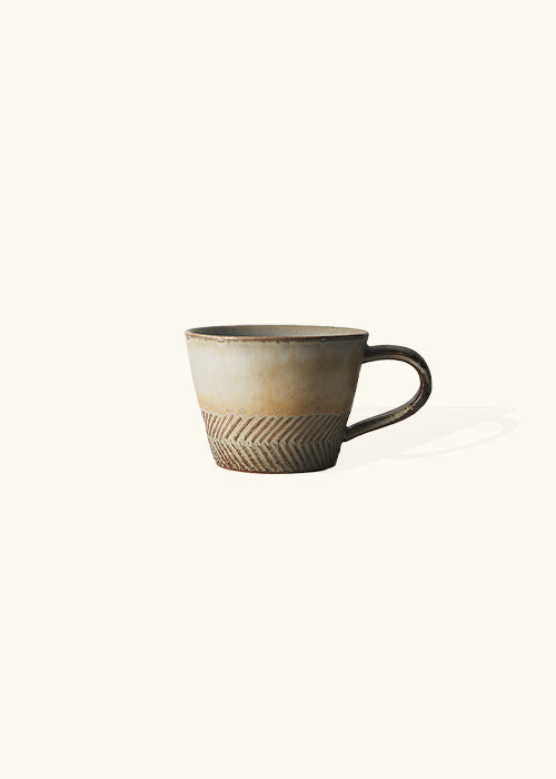 Firelight-inspired mugs, featuring a distinctive, slightly burnt appearance that evokes the cozy ambiance of a crackling fire. Meticulously crafted with precision and care, these mugs harmonize rustic charm with a modern design sensibility. Each sip from these mugs offers a comforting embrace, reminiscent of enjoying your favorite brew by a fireside.
