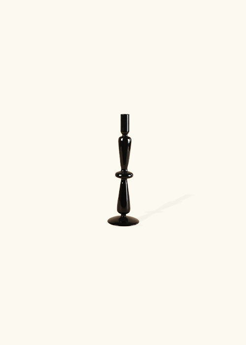 Introducing our Midnight Glass Candlesticks: A perfect fusion of classic charm and modern style. With a uniquely retro-inspired design and a sleek glass construction, these candlesticks effortlessly add sophistication to any space. Elevate your ambiance with this exquisite blend of vintage allure and contemporary elegance. Additional features include black glass candlesticks, available in 3 styles, modern retro style, and unique shapes.