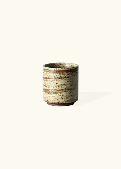 Handmade stone straight mug, measuring W6.3cm x H7cm. Exhibiting a rugged yet sleek style, this mug is part of a comprehensive set of raw pottery dishes and mugs designed for versatile dining needs