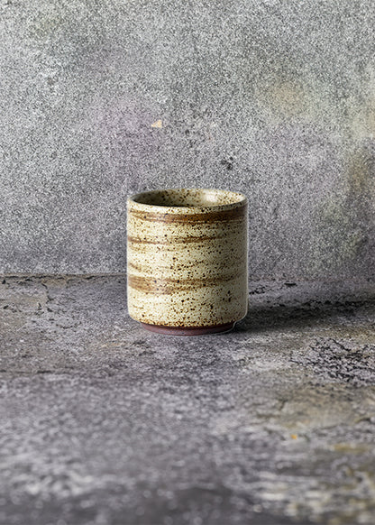 Handmade stone straight mug, measuring W6.3cm x H7cm. Exhibiting a rugged yet sleek style, this mug is part of a comprehensive set of raw pottery dishes and mugs designed for versatile dining needs